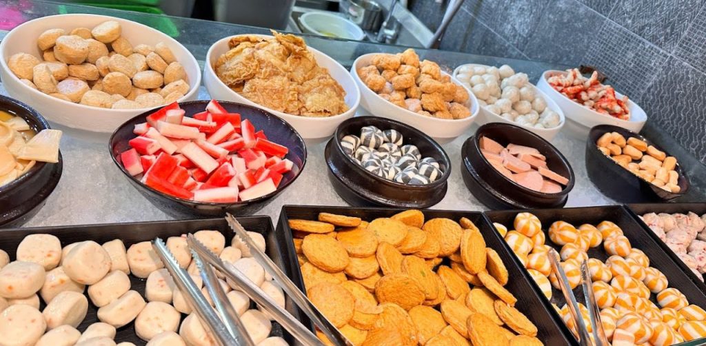 Different kinds of sweet dishes are placed on the table from the overeat buffet menu singapore
